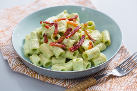 Pasta with zucchini pesto, ricotta, and speck