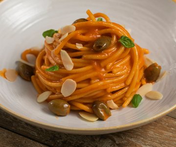 Pasta with roasted pepper cream, olives and almonds