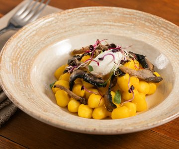 Gnocchi with pumpkin cream, mushrooms and ricotta