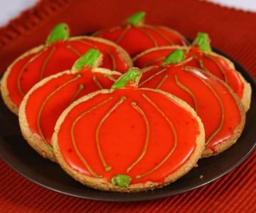 Pumpkin-shaped glazed cookies