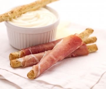 Olive breadsticks with prosciutto and Montasio