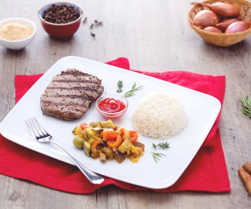 Spicy grilled beef with pilaf rice and spring vegetables