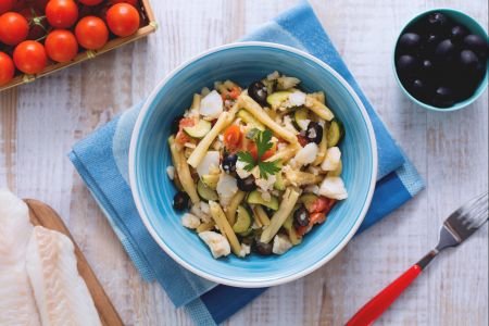 Casarecce with cod sauce, zucchini, and black olives