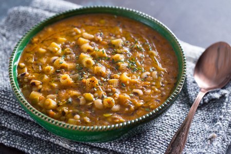 Pasta soup with mixed legumes and bay leaf