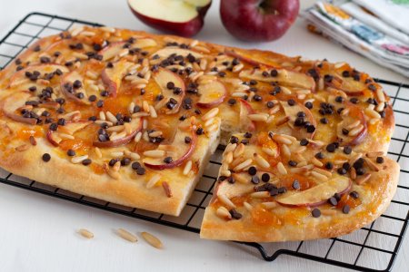 Sweet focaccia with apples, pine nuts, and chocolate