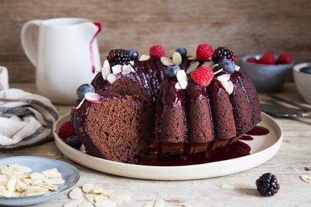 Cake with cocoa and almonds with red fruit sauce