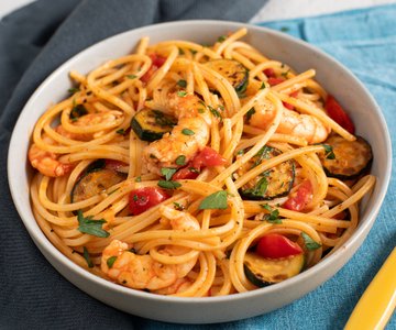 Pasta with zucchini, shrimp, and cherry tomatoes