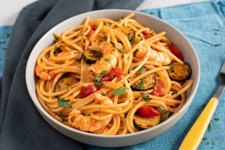 Pasta with zucchini, shrimp, and cherry tomatoes