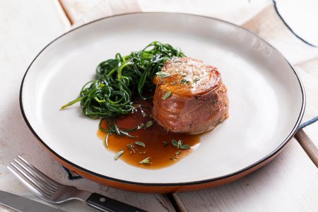 Pork tenderloin wrapped with agretti