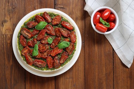 Savory cheesecake with pesto and cherry tomatoes