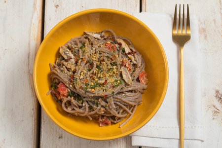 Buckwheat spaghetti with anchovies and cherry tomatoes