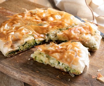 Savory pie with phyllo dough in a pan with zucchini