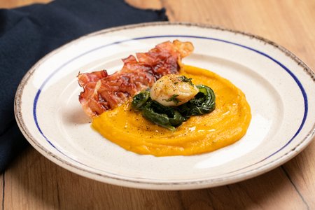 Scallops on Pumpkin Cream with Herbs and Speck