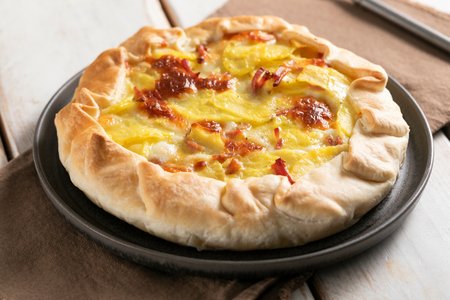 Savory tart with speck and potatoes